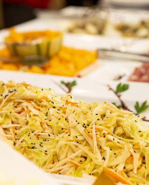 A colorful buffet with fresh salad, spices, and tempting dishes.